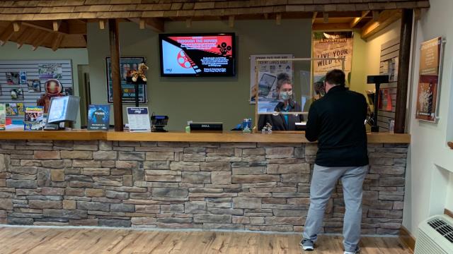 Customer at counter paying for tickets